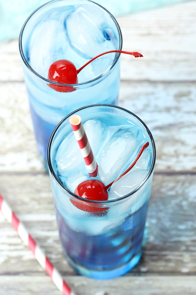 A red and white striped straw is the perfect addition to this blue cocktail.