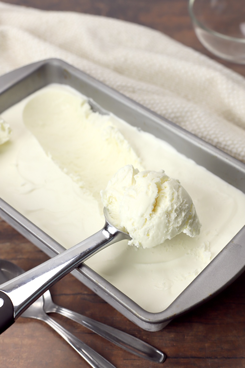 Vanilla ice cream being scooped by an ice cream scoop.