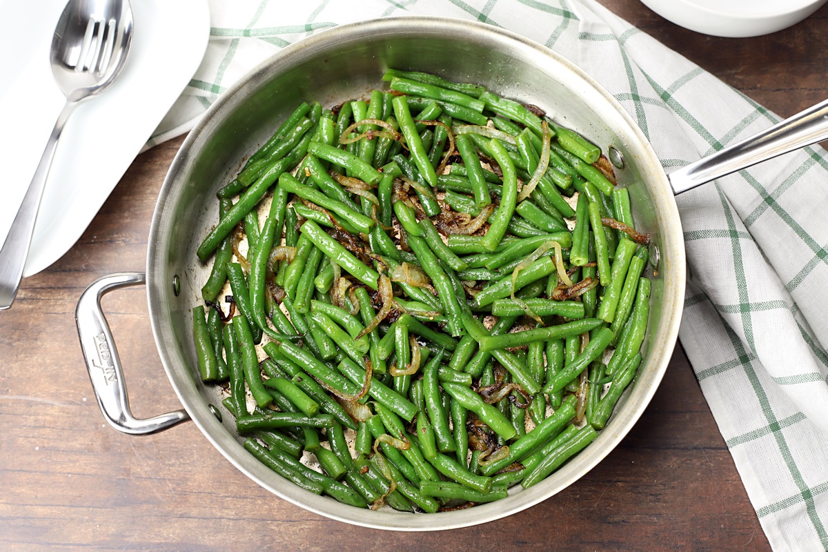 Saute pan filled with green beans, ready to serve. 