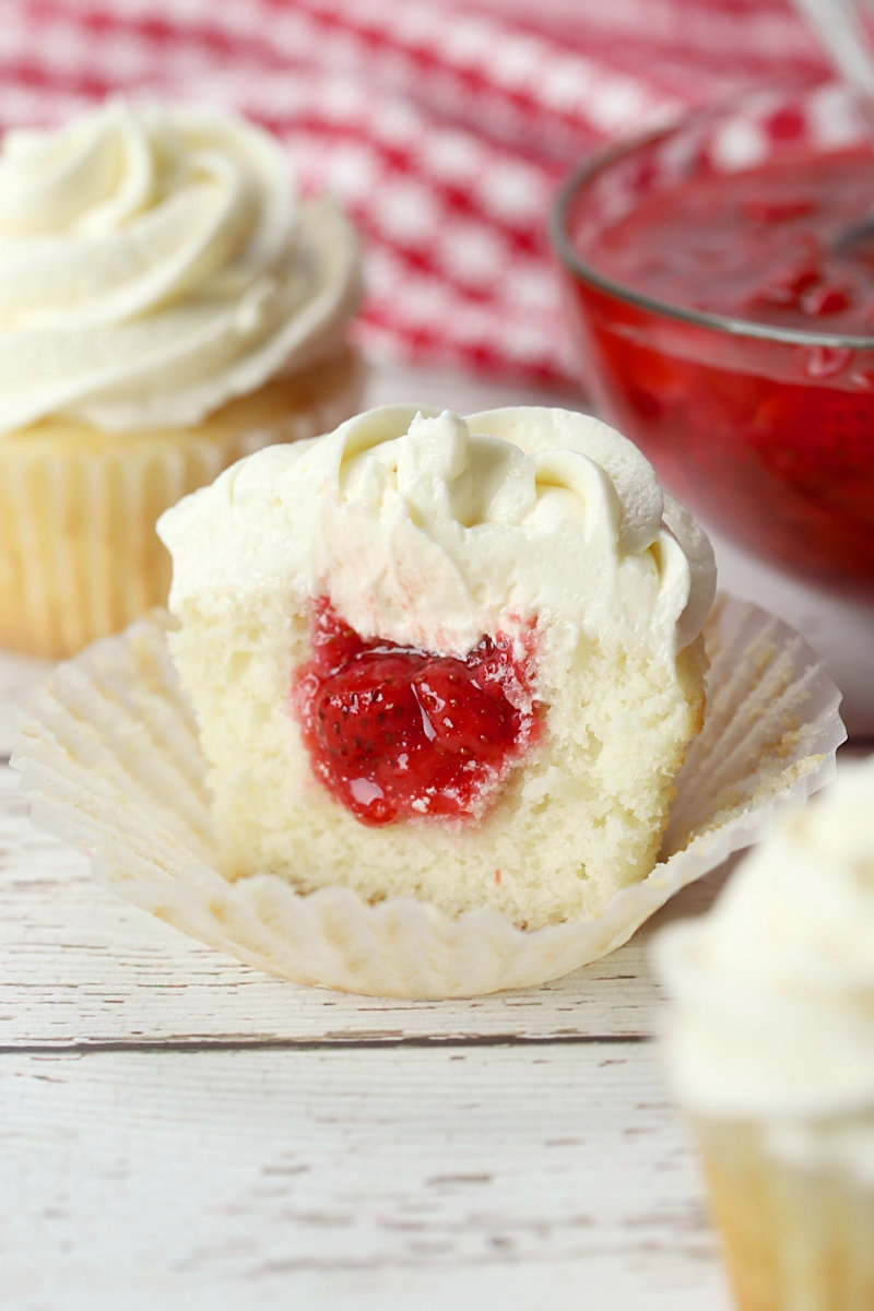 Strawberry filled cupcake sliced in half.