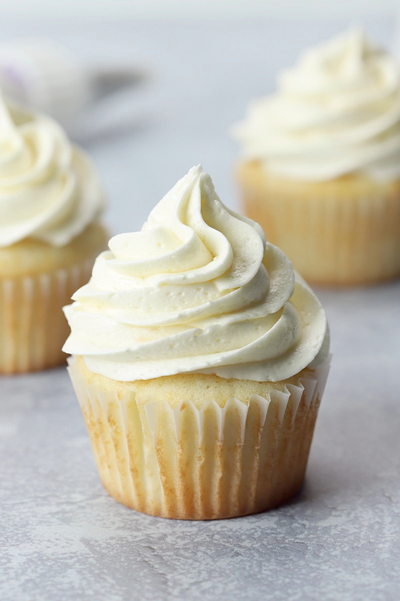 Close up of a white frosted cupcake.