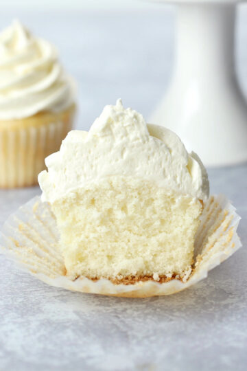 White frosted cupcake sliced in half.
