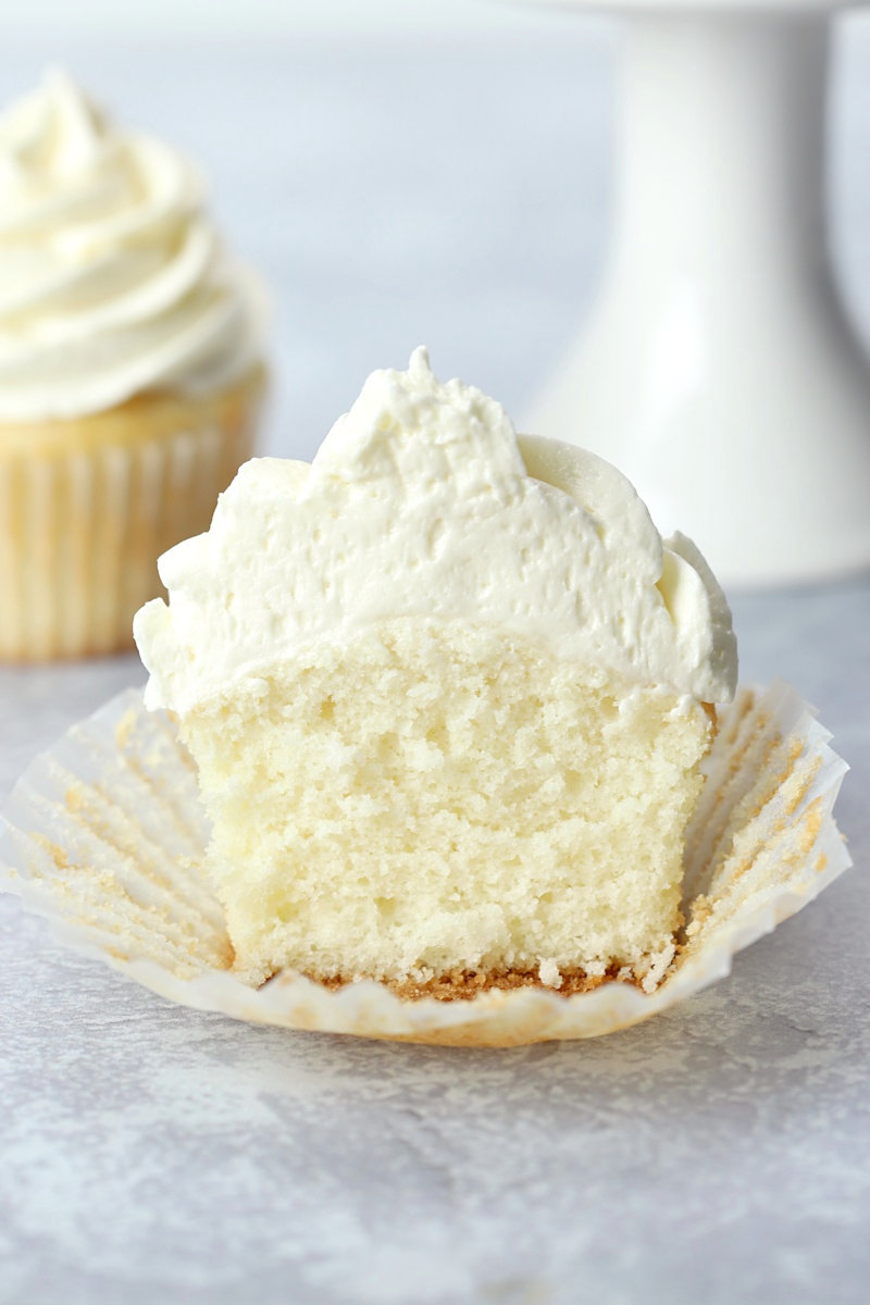 White frosted cupcake sliced in half.