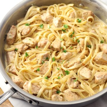 Saute pan filled with pasta and chicken.