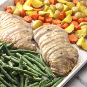 Turkey tenderloin and vegetables on a sheet pan.