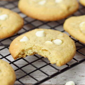 White chocolate macadamia nut cookie with a bite taken out.