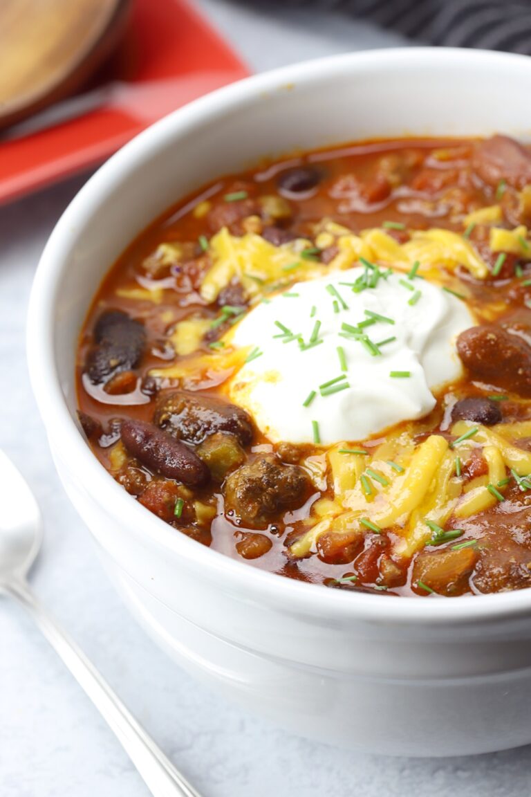 Sour cream and cheese top a bowl of chili.