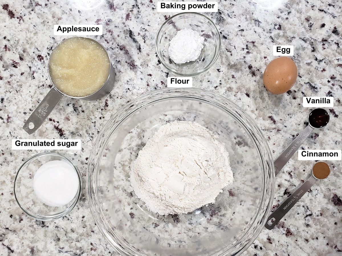 Ingredients for applesauce pancakes measured and ready on a counter top.