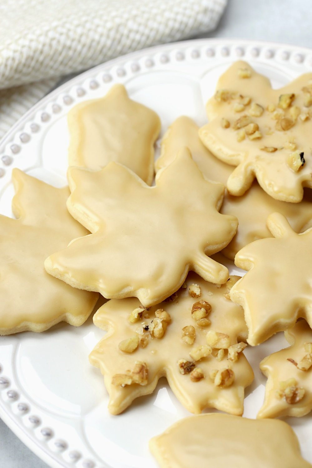 A maple leaf cookie with maple glaze on top.