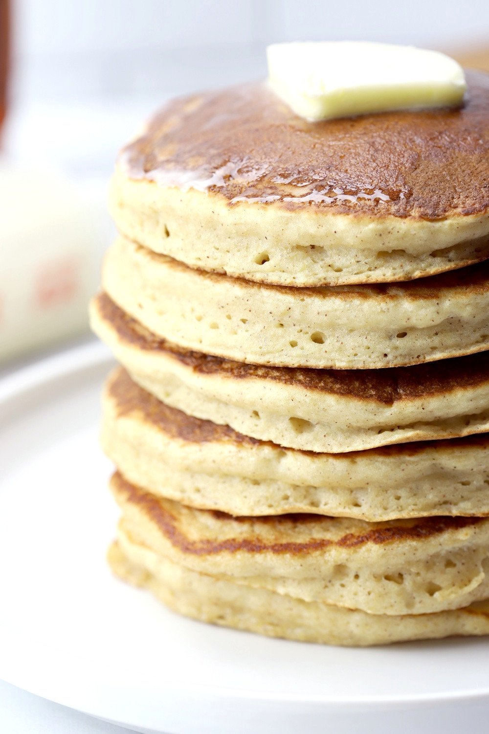 A stack of applesauce pancakes on a white serving plate.