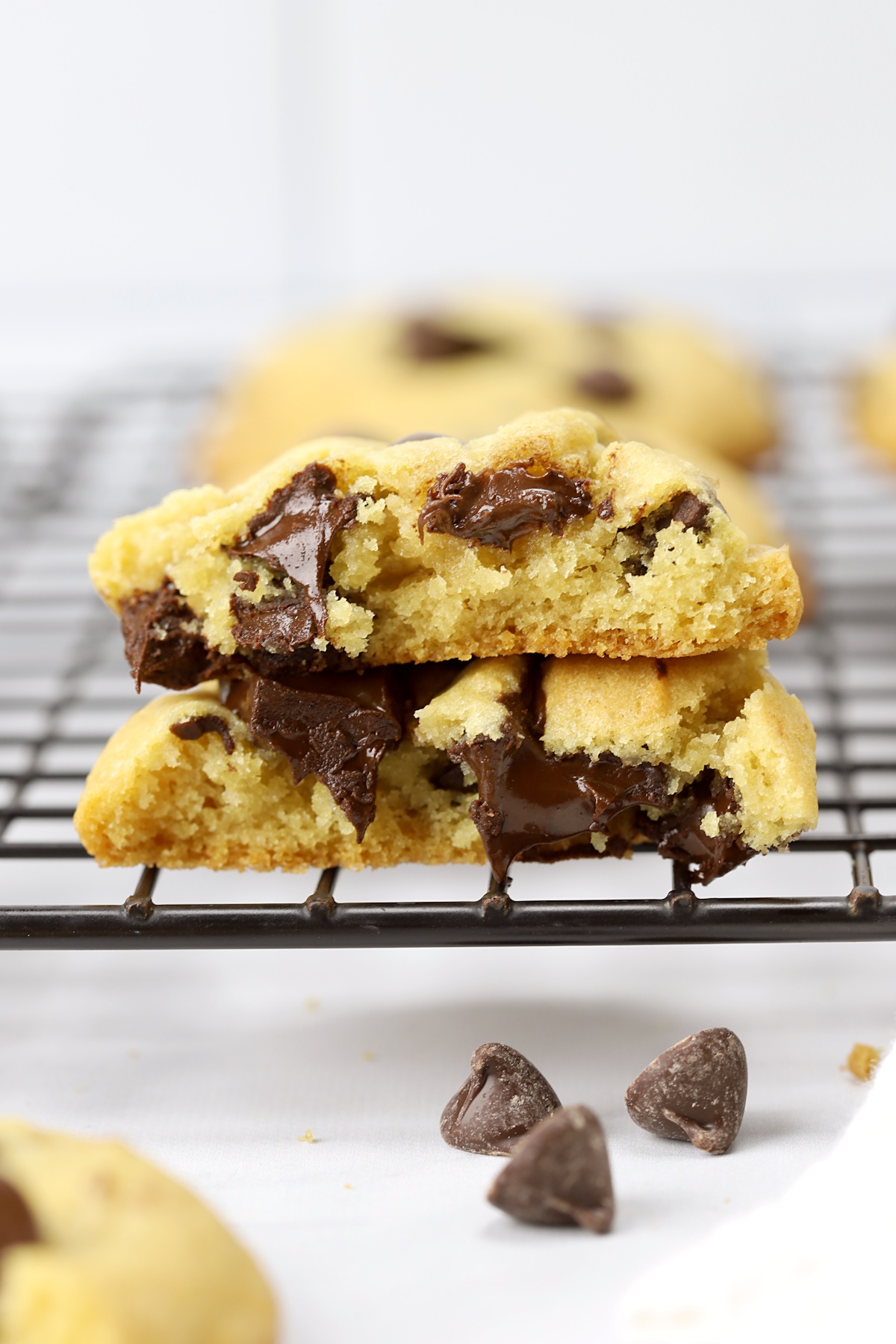 A cookie cut in half to reveal melted chocolate chips.