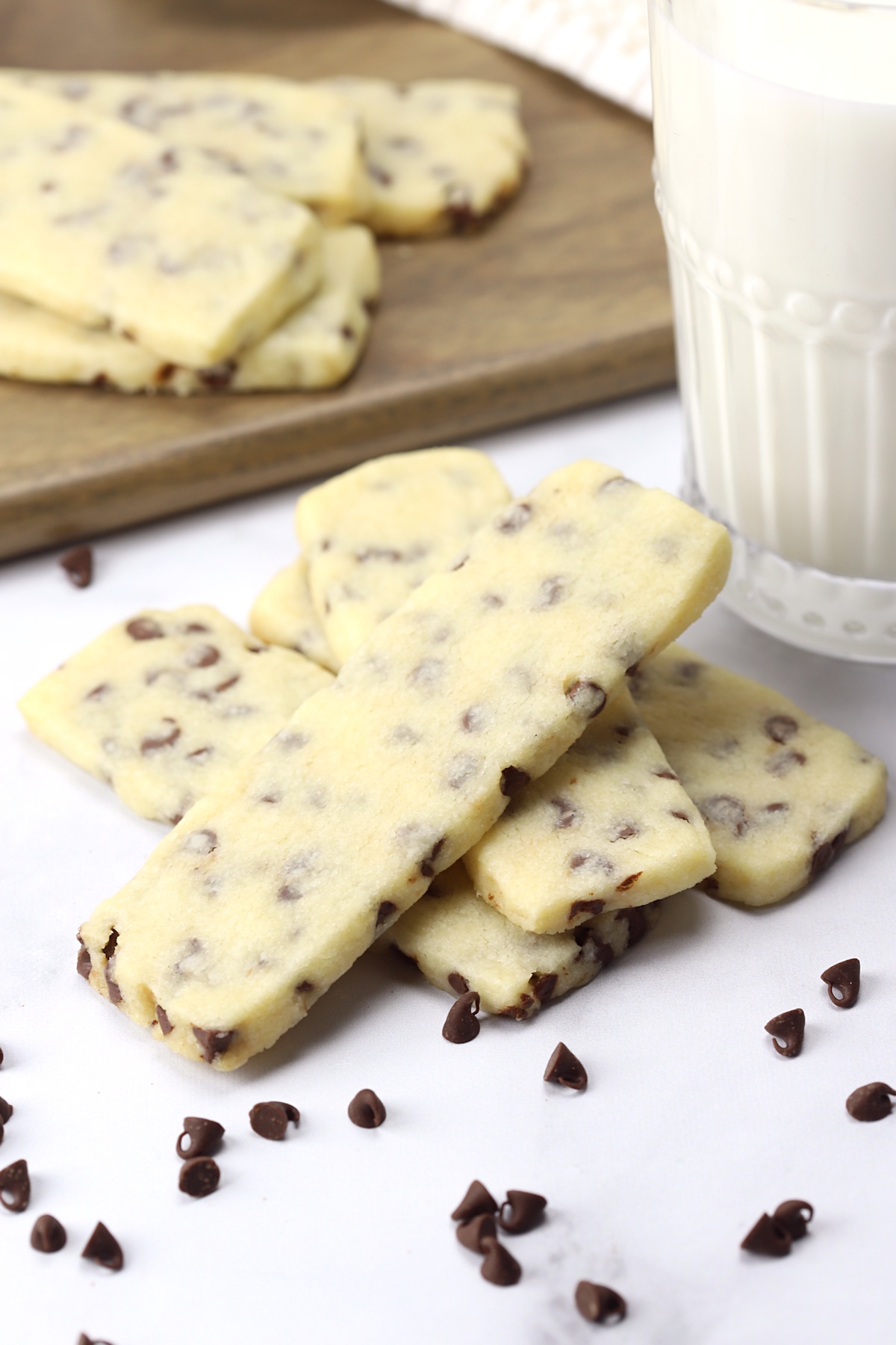 Chocolate chip shortbread cookies with a glass of milk.