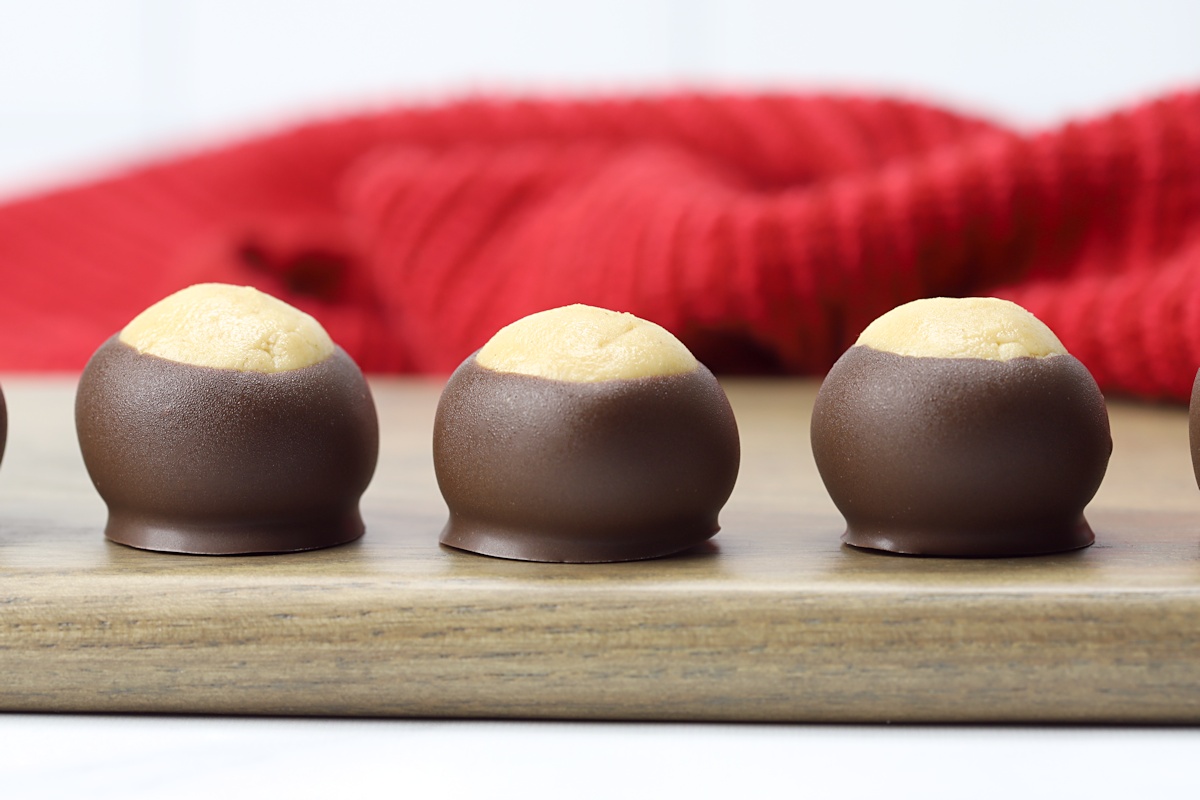 Buckeye candy on a wooden cutting board.