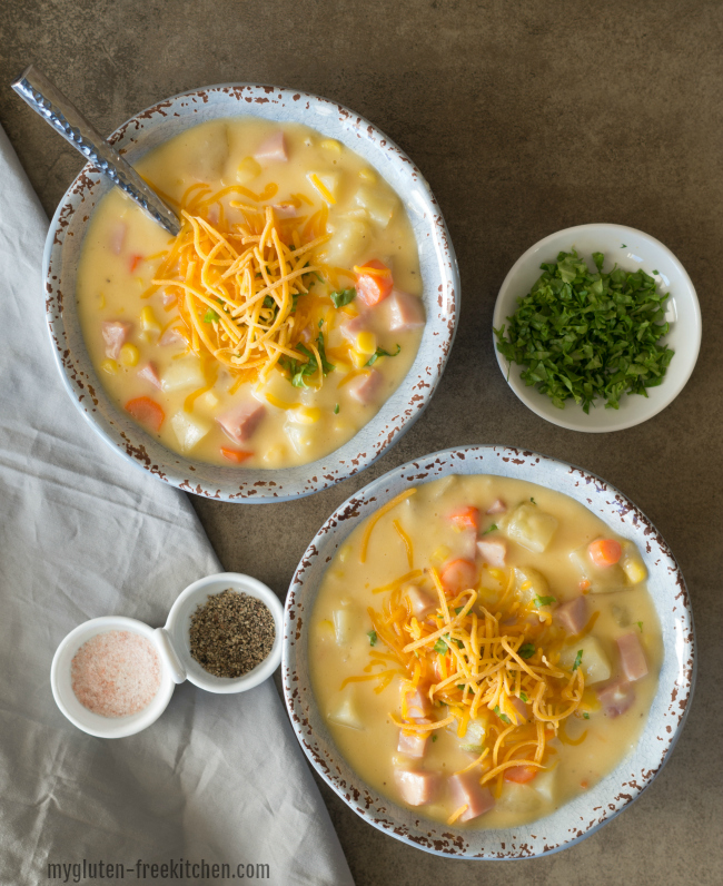 Chowder topped with shredded cheese in two bowls.