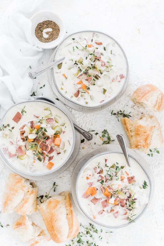 Potato soup served in bowls with crusty bread.