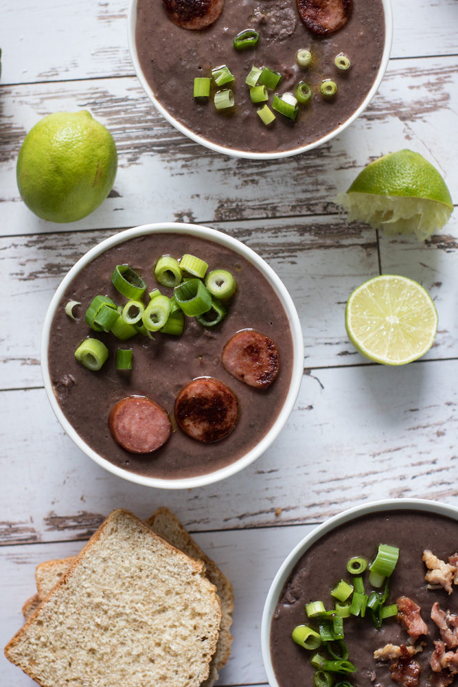 Black bean soup topped with sausage and green onions.