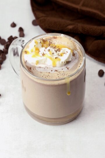Salted caramel hot chocolate in a glass mug.