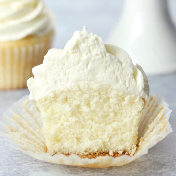 White frosted cupcake sliced in half.