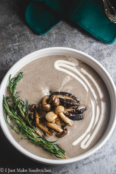 Creamy soup topped with mushrooms and herbs.