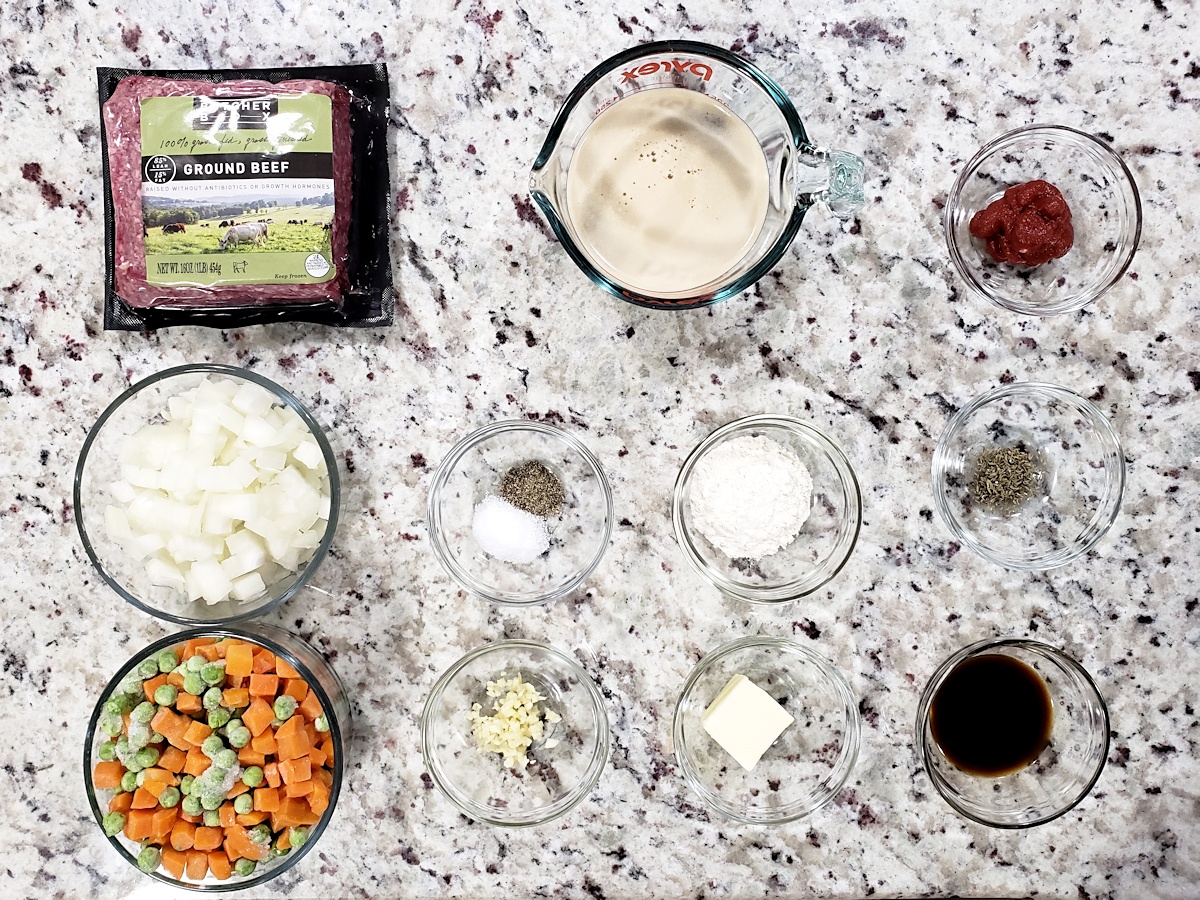 Ingredients laid out to make a beef pie filling.