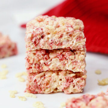 Three strawberry dessert bars stacked on top of each other.