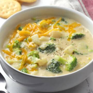 White bowl filled with broccoli potato soup.