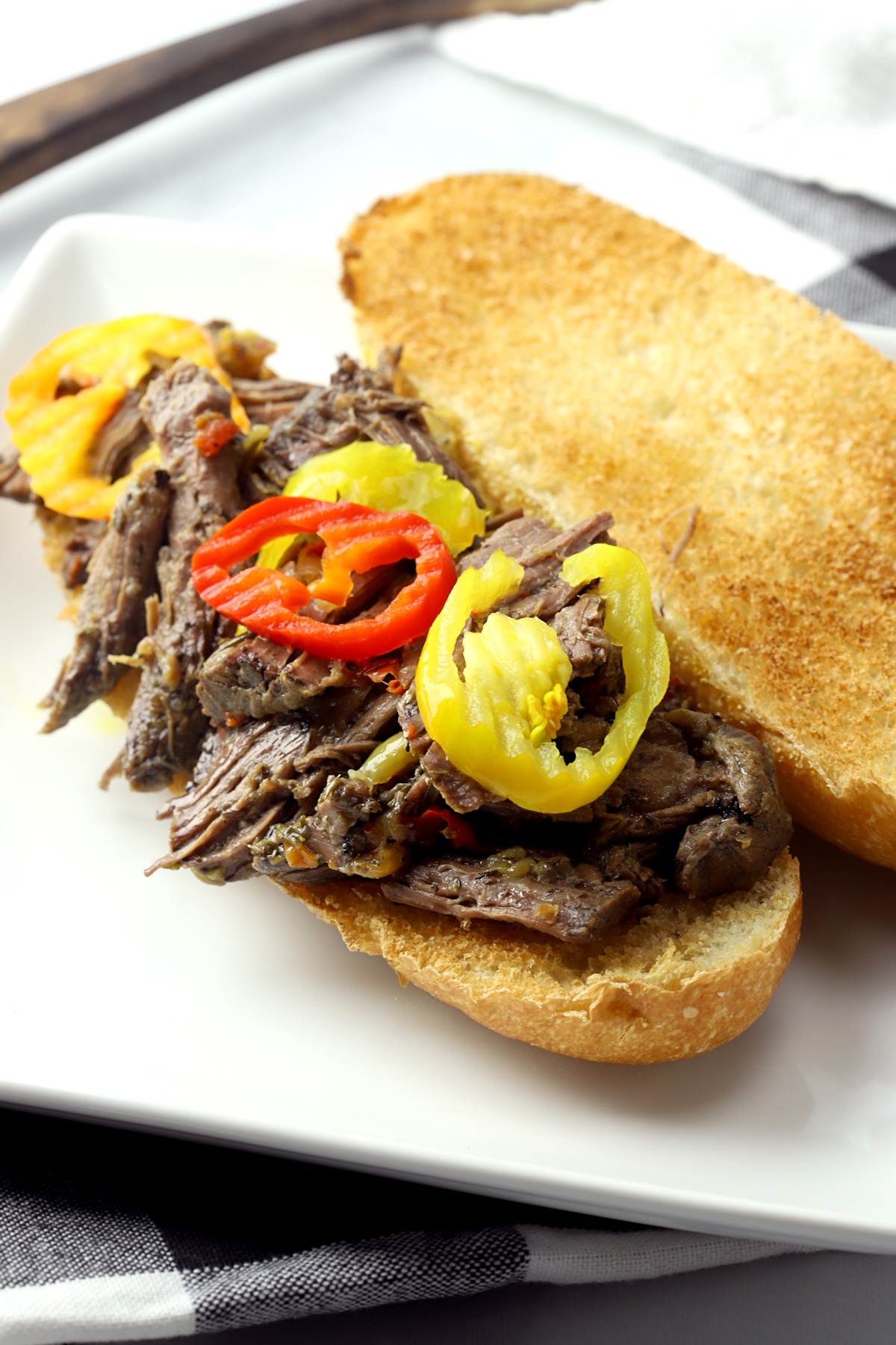 Italian beef sandwich topped with banana peppers.