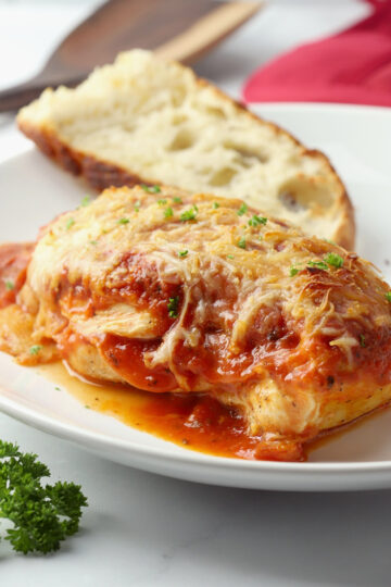 Chicken topped with pizza sauce and melted mozzarella cheese.