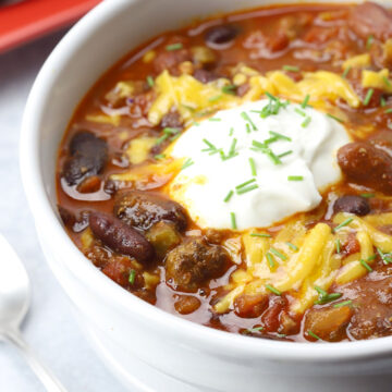 Sour cream and cheese top a bowl of chili.
