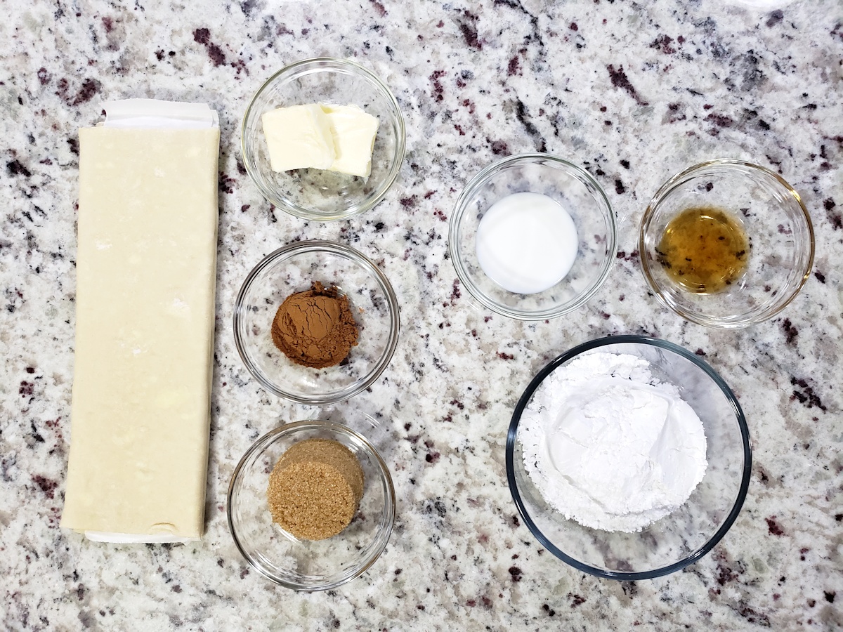 Puff pastry and other ingredients on a counter top.