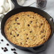A cast iron skillet with a cookie baked inside.