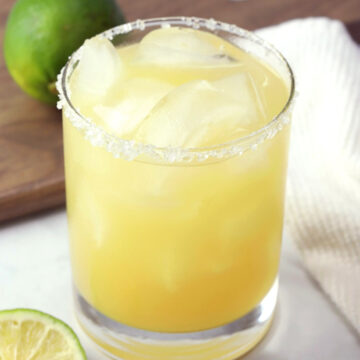 A pineapple margarita in lowball glass.