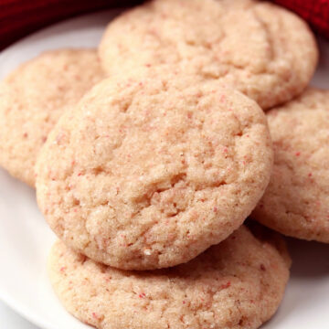 Pale pink cookies on a white plate.