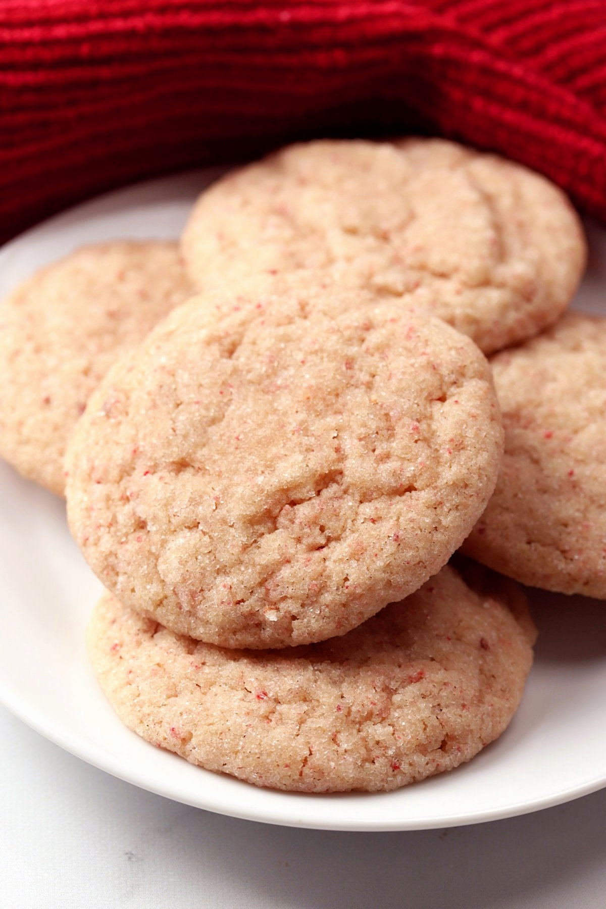 Pale pink cookies on a white plate.