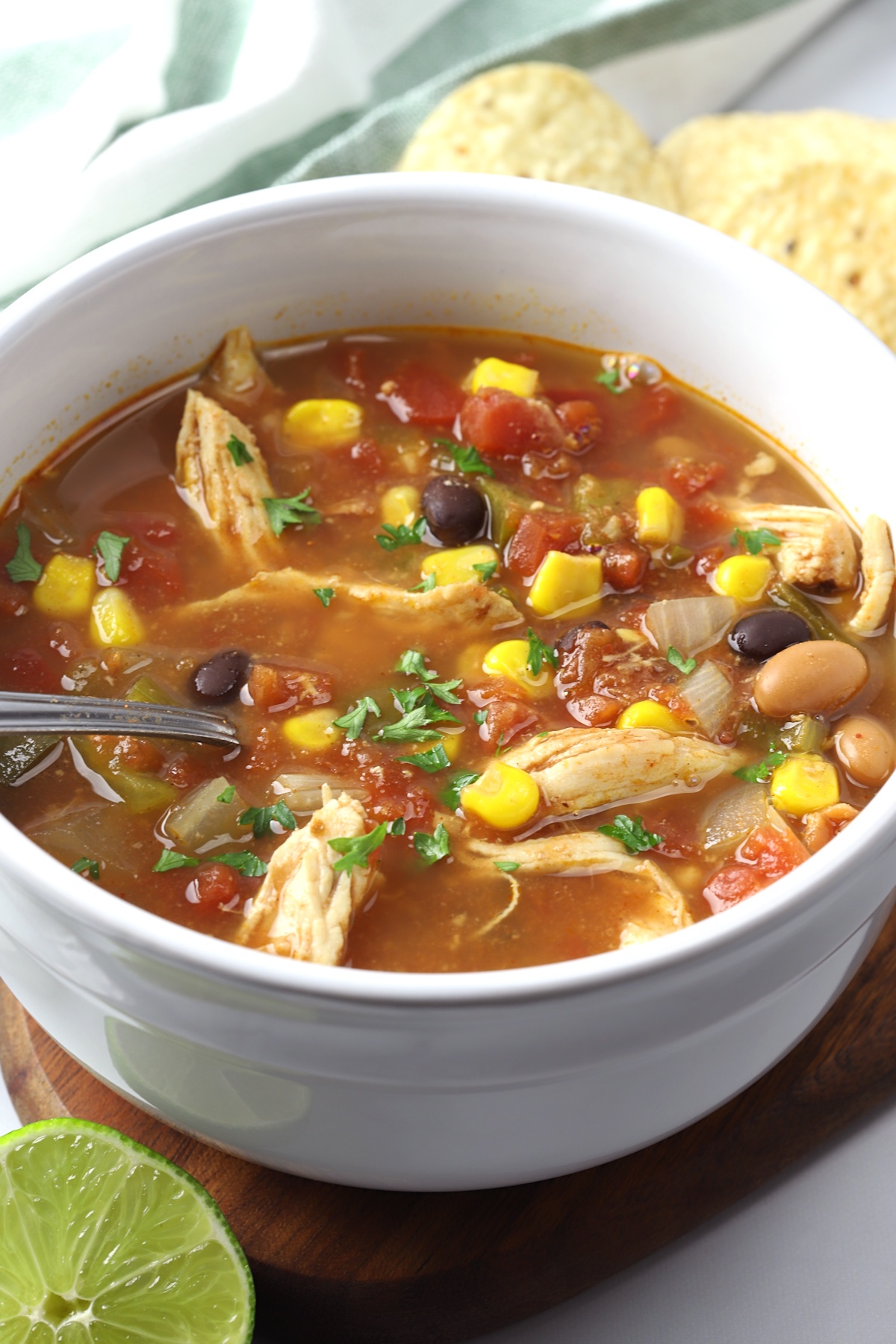 A white bowl filled with slow cooker chicken taco soup.