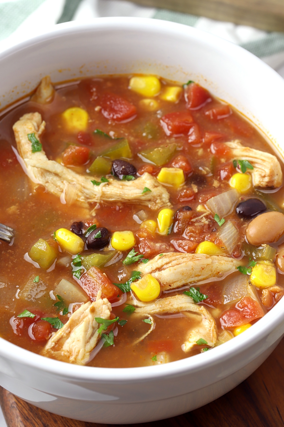 Chicken, beans, corn, and tomatoes in a broth.