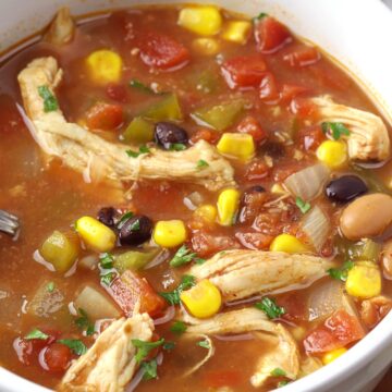 Chicken, beans, corn, and tomatoes in a broth.