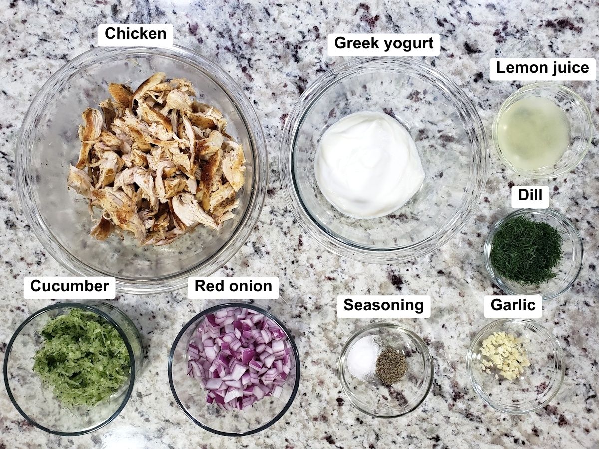 Shredded chicken and other ingredients on a counter top.