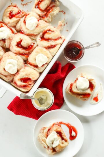 Casserole dish filled with sweet rolls, topped with icing.