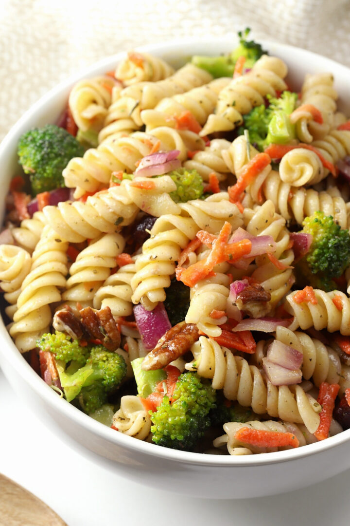 Rotini pasta tossed with grated carrots, broccoli, pecans, and cranberries.