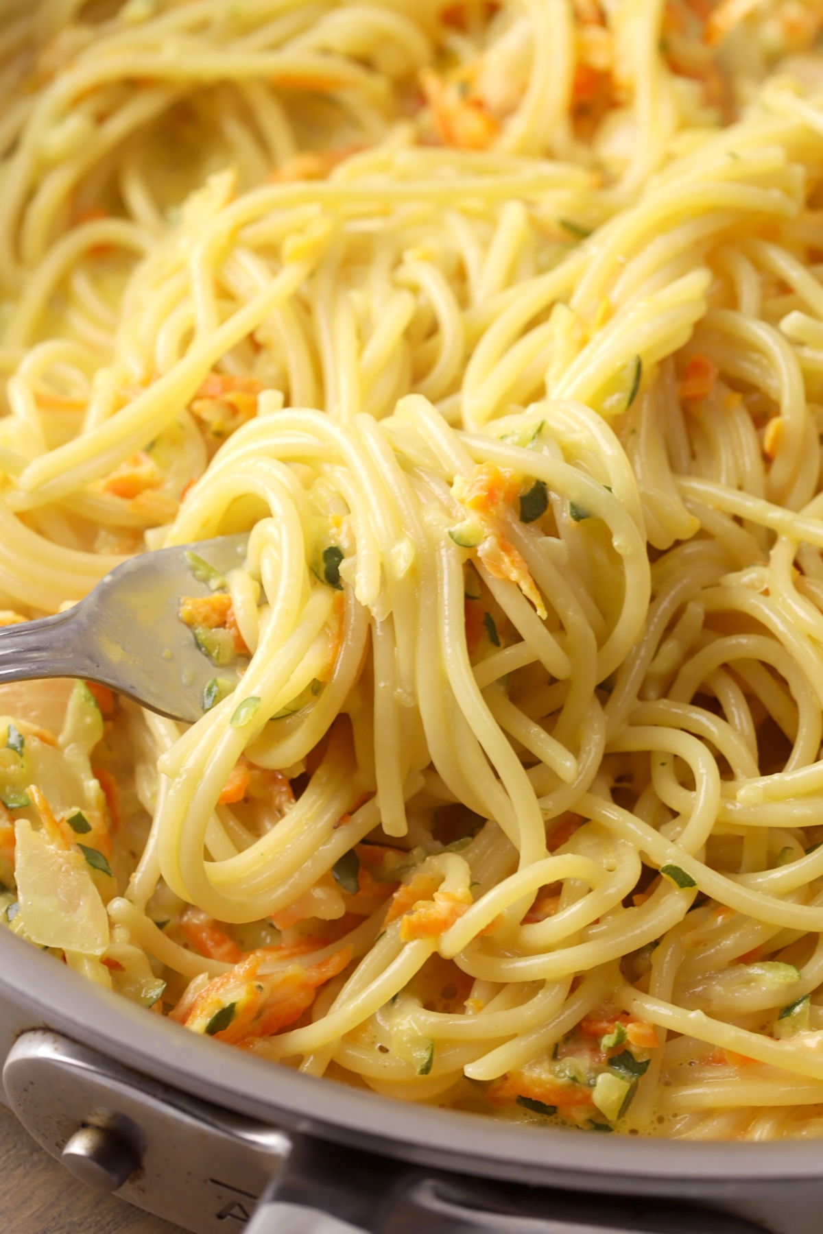 A fork grabbing a portion of spaghetti.