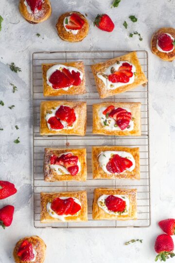 Strawberry tarts on a cooling rack.