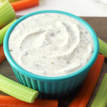 Ranch dip in a teal serving dish.