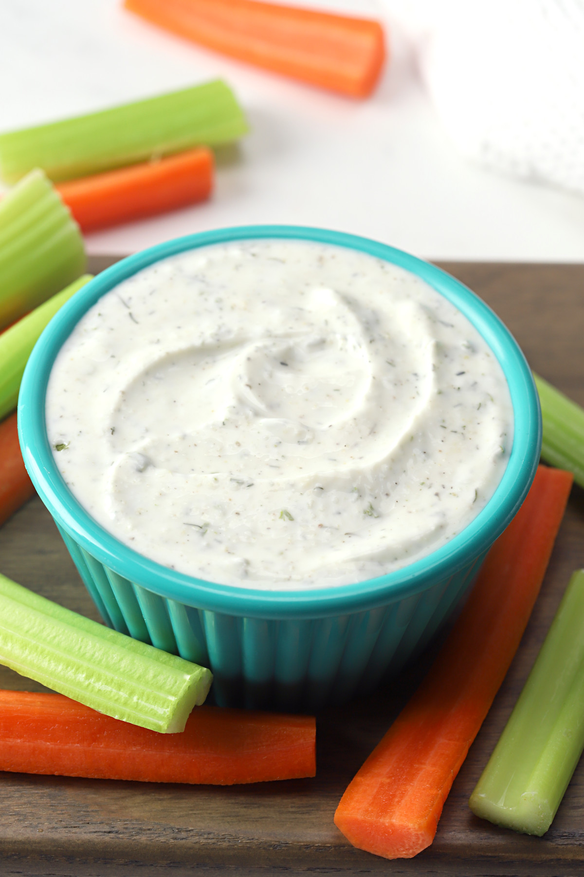 Ranch dip in a teal serving dish.