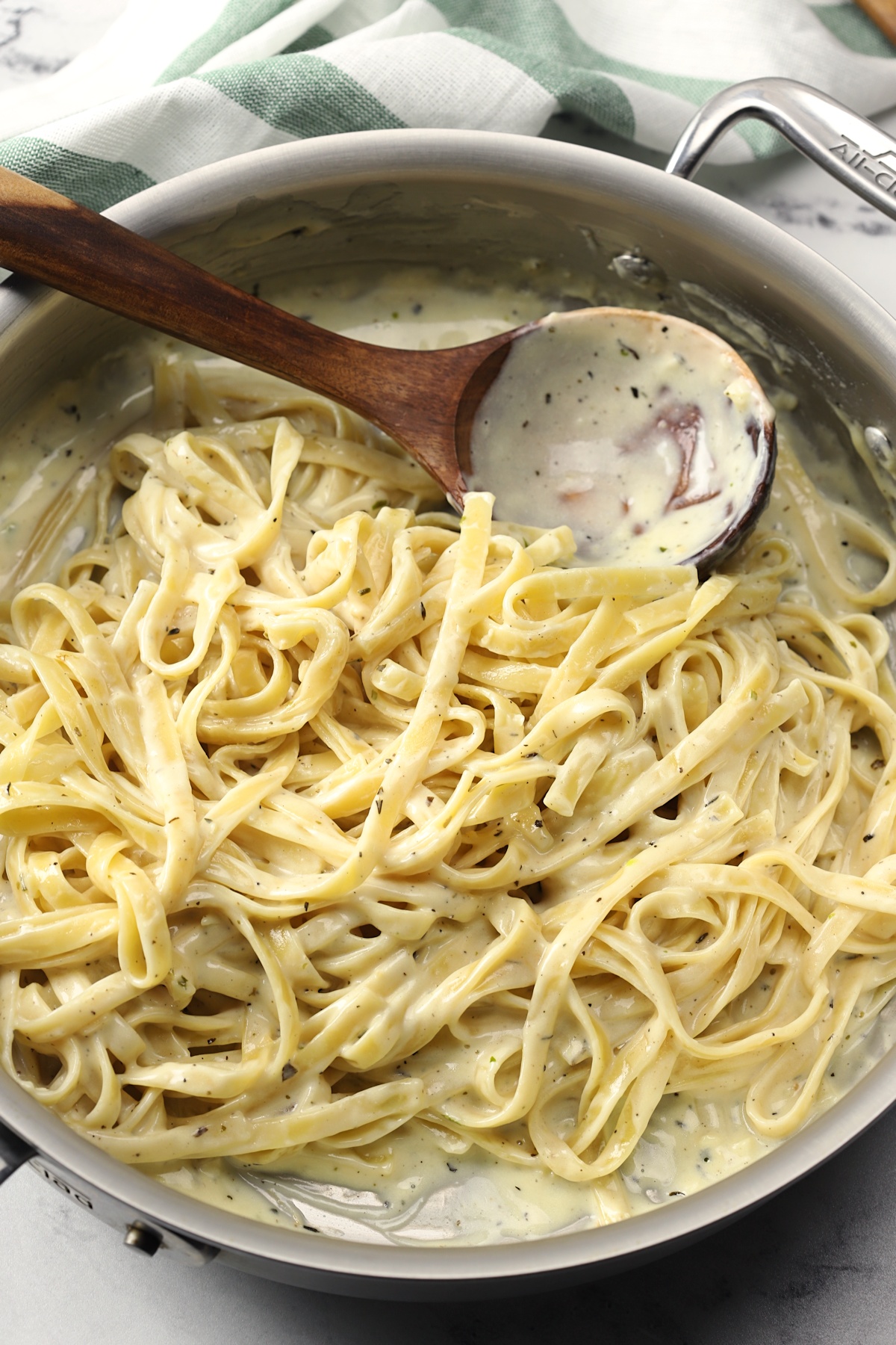 Saute pan filled with fettuccine alfredo.