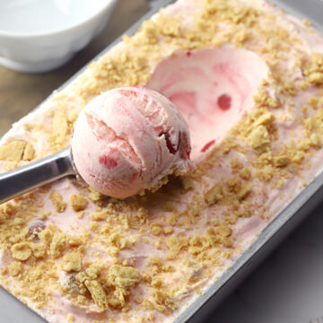 Scooping ice cream from a loaf pan.