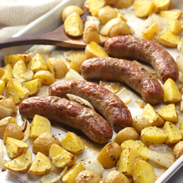 Sheet pan filled with sausage and potatoes.