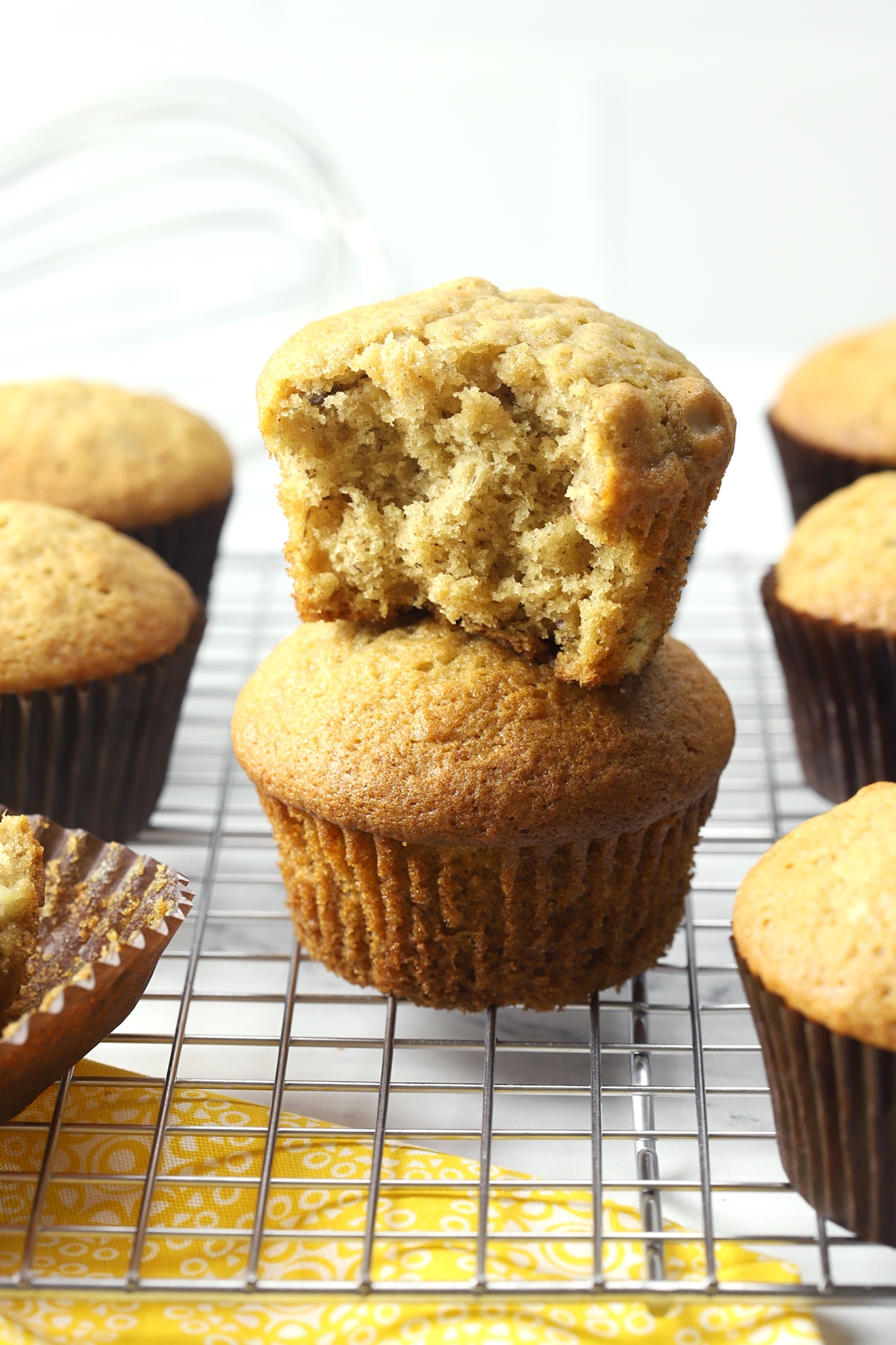 Banana nut muffins stacked on a cooling rack.