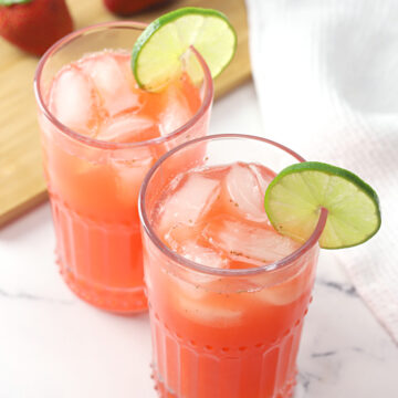 Two glasses filled with strawberry limeade.