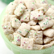 A green bowl filled with Christmas puppy chow.